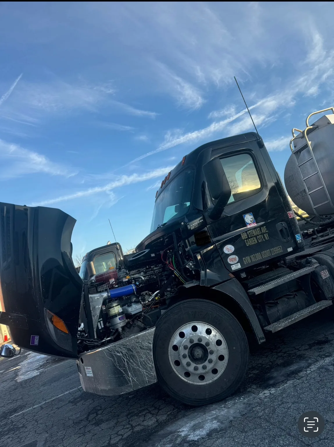 Commercial tractor with its hood open during heavy-duty diagnostics