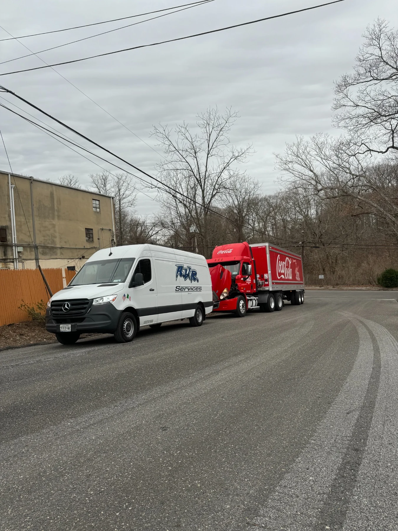 AVR Services van positioned beside a Coca-Cola commercial truck