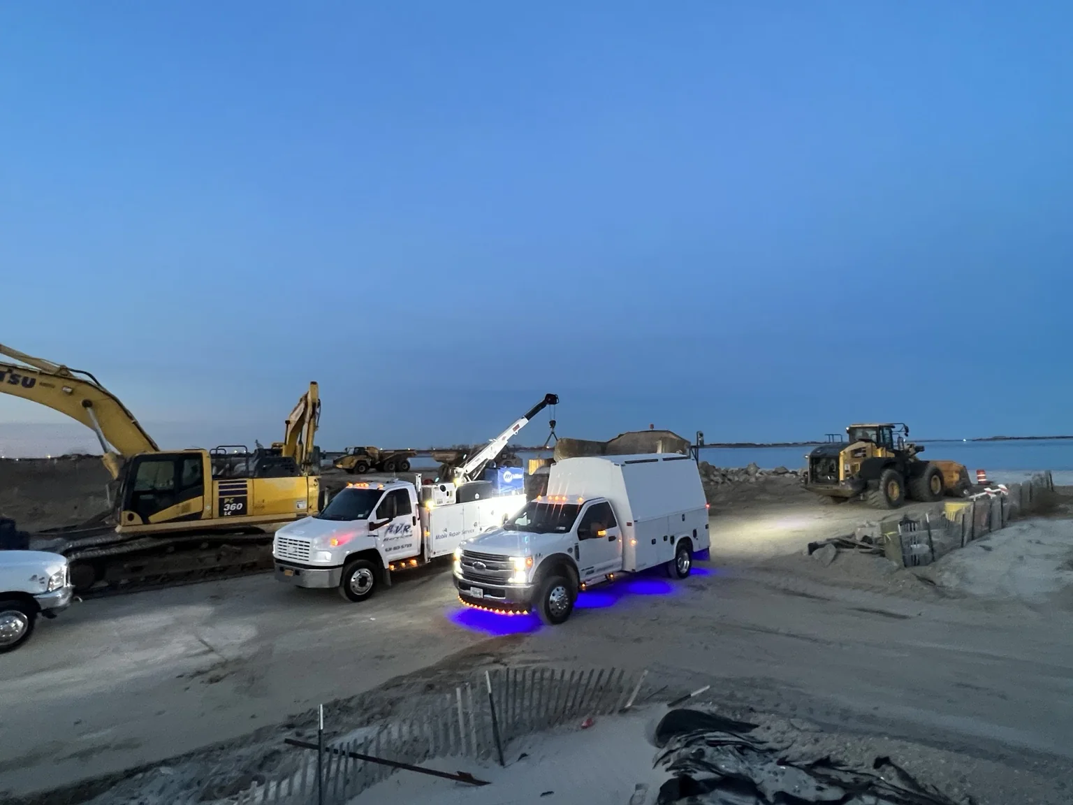 AVR Services trucks working at a heavy-equipment job site
