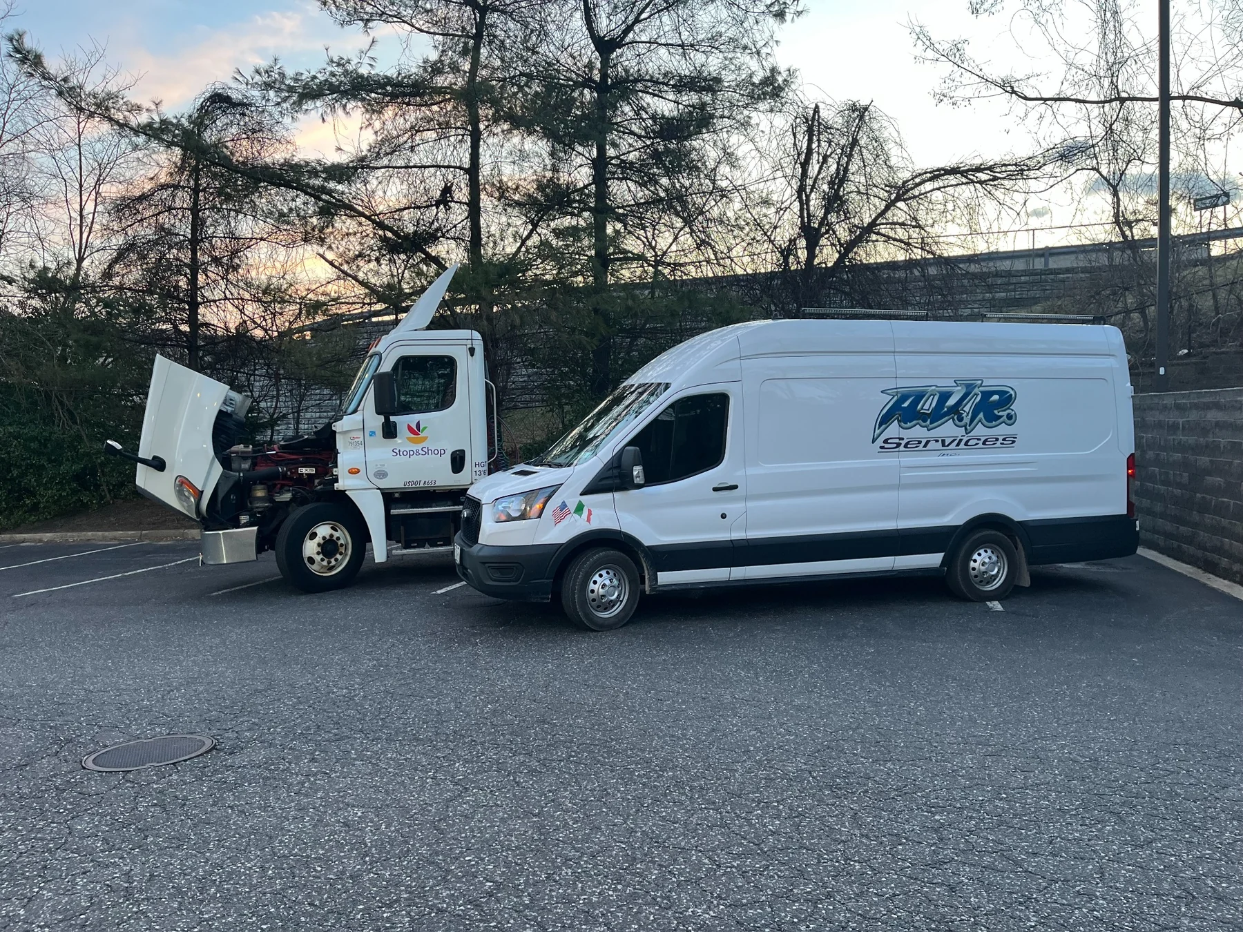 AVR Services van beside a Stop and Shop commercial truck with its hood open